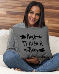 a woman sitting on top of a bed holding a pillow that says, i am an apple