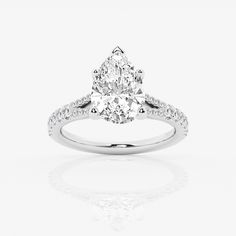 a pear shaped diamond engagement ring on a white background