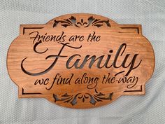 a wooden sign that says friends are the family we find along the way