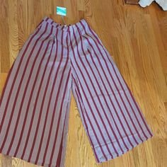 Umgee Women's Wide-Leg Pants. Soft And Flowy Polyester. Pleated Front With Pockets. Burgundy With Off-White Stripes. Red Wide Leg Bottoms For Day Out, Red Wide Leg Pants For Day Out, Red Wide-leg Pants For Day Out, Trendy Red Pants For Day Out, Black Bell Bottoms, Ruffle Linen, Camouflage Pants, Womens Wide Leg Pants, Black Wide Leg Pants