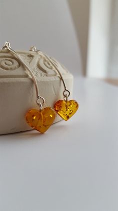 ❤ The Amber Heart earrings - are not just a piece of jewelry, but also a symbol of love, protection, and hope. The warm, golden-brown hues of Baltic Amber have been prized for centuries for their beauty, and believed to have powerful healing properties. These beautiful heart shaped earrings are made of genuine cognac & lemon Baltic Amber stones.  ❤ Minimalistic style earrings are small - the amber stone diameters:  1 x 1 cm (0.39 x 0.39 inches), the silver sterling 925 wire part lenght is 2.5 cm (0.98 inches). ❤ Such jewelry is always a perfect gift for every woman and for any occasion. Especially amber stones add luxury and romance to the whole style & make it look more exclusive, because every amber stone is unique. These earrings perfectly match casual or formal style. Cognac amber earr Teardrop Heart Earrings For Gift, Sterling Silver Dangle Jewelry With Heart Charm, Heart Dangle Earrings As Gift, Round Earrings With Heart Charm As A Gift, Nickel-free Heart Pendant Earrings For Anniversary, Nickel Free Dangle Heart Earrings For Anniversary, Sterling Silver Heart Charm Drop Earrings, Sterling Silver Teardrop Jewelry With Heart Charm, Heart-shaped Jewelry With Ear Wire For Gifts