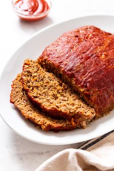 sliced meatloaf on a plate with ketchup