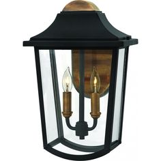 an outdoor wall light with two candles on the front and back of it, in black