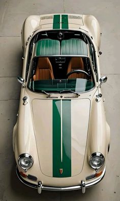 an old white and green sports car parked in a garage