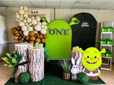 an assortment of items displayed in front of a one sign and balloon tree stumps