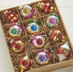 an open box filled with assorted christmas ornaments