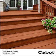 a wooden porch with flowers on the steps