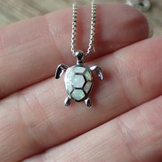 This is a very beautiful opal turtle charm. It measures 1/2” long from the top of the jump ring, 1/2" wide and is solid sterling silver with inlaid white lab created opal. T his charm is photographed on a 1 mm sterling silver rounded box chain which is sold separately. It can be found here. The turtle symbolizes many things. Most of us know the story of the tortoise and the hare, reminding us that slow and steady wins the race. The turtle also symbolizes the earth, staying grounded, wisdom and e White Sterling Silver Nature-inspired Jewelry, Nature-inspired White Sterling Silver Jewelry, Nature-inspired Silver Jewelry For Gifts, Nature-inspired Silver Jewelry For Gift, Nature-inspired Sterling Silver Jewelry, Staying Grounded, White Lab, Turtle Charm, Turtle Necklace