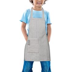 a young boy wearing an apron and blue t - shirt standing in front of a white background