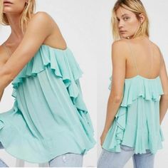 A Voluminous Intimately By Free People Cami With Cascading Ruffles In A Dreamy Seafoam Green Color. Swingy Relaxed Fit, I Would Say This Runs A Little Large. Features A Square Neckline With Spaghetti Straps. Popover Style With A Slight High Low Hem. A Little Sheer, Girly And Flirty With Amazing Movement! Beautiful Blue Green Color. This Top Is New Without Tags But Came In With A Very Small Spot On The Back Ruffle. See Photo. Measures 15" Flat Pit To Pit; 26" Strap To Hem (Approximately) Trendy Blue Flowy Top, Blue Trendy Loose Fit Tops, Trendy Light Blue Ruffled Top, Trendy Ruffled Tops For Summer, Trendy Blue Ruffled Tops, Feminine Light Blue Summer Tops, Trendy Blue Tops With Ruffles, Light Blue Feminine Ruffle Tops, Flowy Summer Tops With Ruffled Straps