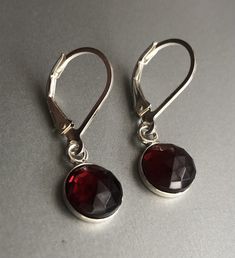 "Genuine Garnet Earrings Sterling Silver, Red Garnet Earrings Drop, January birthstone These garnet earrings will make a great gift! They made from: - Genuine faceted Mozambique red garnet 8mm cabochons set in sterling silver - Sterling silver lever back ear wires The earrings are about 1 \" long. Your order will be mailed within 2 business days nicely packaged and ready to be given. All US orders and most international orders will have tracking#. To see more of my jewelry: https://www.etsy.com/ Red Garnet Earrings, January Birthstone, Garnet Earrings, Earrings Drop, Gift For Wife, Earrings Sterling Silver, Red Garnet, Mozambique, Sterling Earrings