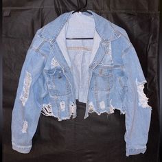 Ripped Jean Jacket With Cuffed Sleeves Eight Buttons, All Intact And In Good Condition Never Worn Size Extra Small 85% Cotton, 15% Polyester Ripped Long Sleeve Outerwear For Winter, Ripped Long Sleeve Outerwear For Streetwear, Winter Ripped Long Sleeve Outerwear, Casual Cropped Outerwear With Zipper Closure, Blue Ripped Winter Outerwear, Trendy Ripped Winter Outerwear, Winter Ripped Blue Outerwear, Winter Blue Ripped Outerwear, Ripped Cropped Fall Outerwear