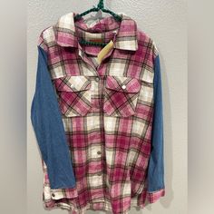 a pink and blue plaid shirt hanging on a wall