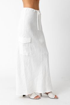 The Kaia White Linen Cargo Maxi Skirt is the perfect vacation cover-up! White linen woven fabric shapes this cargo maxi skirt with a mid-rise fit and drawstring tie. Style with sandals and a cute top and wear to dinner! DETAILS & FIT Loose Fit. 100% Linen. Machine wash cold. Imported. ORDERS, SHIPPING & RETURNS Orders, Shipping, & Returns