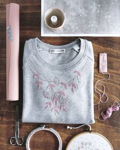 some crafting supplies are laid out on a table with yarn, scissors and thread