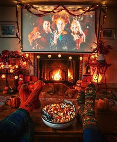 a person sitting in front of a fire place with their feet up on the table