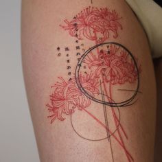 a woman's thigh with flowers on it and the words written in cursive writing