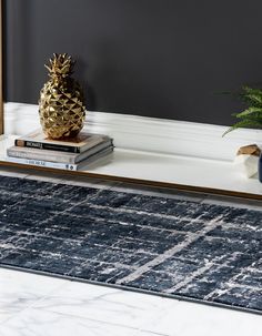 a pineapple sits on top of a bookshelf next to a blue rug