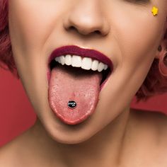 a woman with pink hair sticking out her tongue