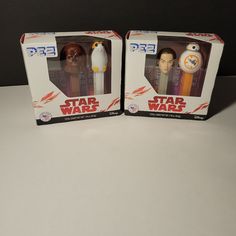 two star wars action figures are in their boxes