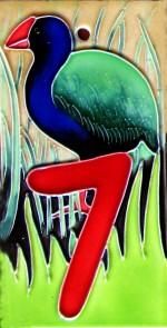 a painting of a bird on the side of a building with grass and trees in the background