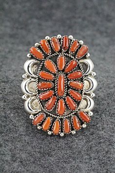 This stunning coral and sterling silver ring was made by Navajo silversmith Justina Wilson. The back is signed JW and stamped sterling. Size: 8 Length: 1 7/8" Width: 1 1/2" Free shipping on all orders! We ship with USPS and always include tracking. All orders ship within a day of payment. Returns are accepted up to 30 days after you receive your order. Just send us a message. Our shop offers cash back or store credit. The item must be returned in new condition. Southwestern Sterling Silver Red Ring, Southwestern Red Sterling Silver Ring, Navajo Rings, Sterling Silver Ring, Favorite Jewelry, Silver Ring, Sterling Silver Rings, Jewelry Watches, Jewelry Rings