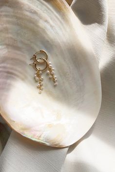 "Completely handcrafted in our New York studio, the Pearl Dust Mini Hoop Earrings are composed of signature clustering of freshwater pearls. Lightweight and easy to wear. Wear them two ways - slide the dangle off to wear just the simple hoop earring. Ear wires: hoop Materials: 14k Gold Filled or Sterling Silver Measures approx. 1 3/4\" in length Handmade in New York Arrives perfectly packaged, ready for gift-giving!" Mini Jewelry, Gold Hoop Pearl Earrings, Gold And Pearl Earrings, Affordable Fine Jewelry, Elizabeth Jewelry, Simple Hoop Earrings, Cool Piercings, Mini Hoop Earrings, Pearl Hoop Earrings