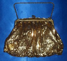 "Vintage purse and handbag enthusiasts know how collectible Whiting & Davis pieces are. This little beauty is no exception. It has gold lining with a little pouch for storage, nicely made, heavy and very shiny gold! It has a gorgeous ribbed gold tone frame stamped inside and a kiss lock closure. This esteemed manufacturer of ladies accessories certainly crafted some attractive bags! In lovely condition, measures 5.5\" tall (9\" including chain) and 7\" wide. I see no issues, kiss lock in gre Amp Davis, Art Deco Vanity, Ladies Accessories, Vintage Purse, Gold Line, A Kiss, Clutch Handbag, Vintage 1950s, Evening Bags