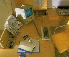 an old computer sitting on top of a wooden desk