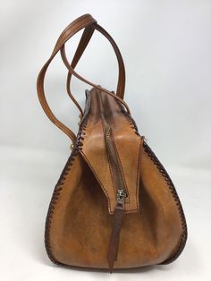 "Measures 13\" in length/ 9\" in height /4\"-7\"sides/strap drop 6\"/Good vintage condition /no issues /clean interior /smoke-free home (122)" Vintage Hand-tooled Tote Satchel, Vintage Hand Tooled Tote Satchel, Vintage Style Hand Tooled Tote Satchel, Retro Hand-tooled Bag For Everyday Use, Retro Hand Tooled Shoulder Bag For Daily Use, Retro Hand Tooled Shoulder Bag For Travel, Retro Hand Tooled Bag For Everyday Use, Retro Hand Tooled Bag, Vintage Brown Hand Tooled Rectangular Shoulder Bag