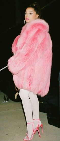 a woman in pink fur coat and white tights