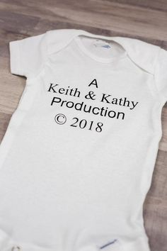 a white bodysuit with the words, a kelth & kathy production on it