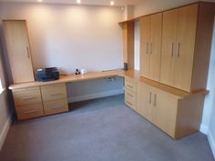 an empty room with some cabinets and drawers on the wall, including a printer machine