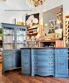 an antique store with blue painted furniture and chandelier