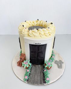 a cake that is shaped like an entrance to a building with doors and flowers on it