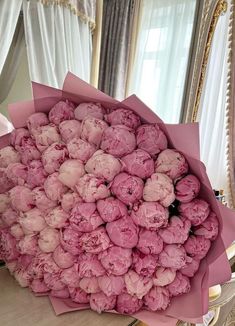 a bouquet of pink flowers sitting on top of a table