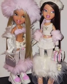 two dolls are dressed in furry clothes and hats