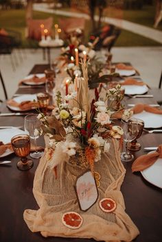 the table is set with candles and plates