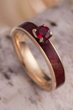 Ruby redwood lines the inlay of this ruby engagement ring from Jewelry by Johan. #JewelrybyJohan #Handmade #Ruby Ruby Engagement Ring Men, Ruby Wedding Rings Men, Ruby Mens Wedding Band, Engagement Ring With Ruby, Ring With Ruby, Ruby Wedding Rings, Wooden Wedding Ring, Jewelry By Johan, Inlay Jewelry