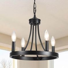 a black chandelier with five lights hanging from it's center and two sides