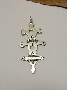 Typical and traditional Berber Tuareg solid sterling silver amulet. Featuring traditional Tuareg geometry representing the Tuareg tent, shifting desert sands and animal track motifs. Made in the cross shape to mimic the compass points and aid desert navigation with the night sky. Worn externally on the clothing (turban or necklace) as practical decoration. Silver stamped: Hallmark Weight: 5.8  grams Shipping : DHL EXPRESS 🙂 Traditional Ankh Silver Jewelry, Traditional Silver Ankh Jewelry, Traditional Silver Cross Pendant Jewelry, Traditional Cross Pendant For Ceremonial Occasions, Ceremonial Silver Cross Jewelry, Silver Cross Jewelry For Ceremonial Occasions, Cross Shape, The Compass, Statement Ring Silver