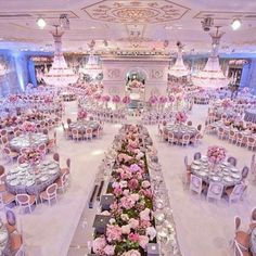 a banquet hall with tables and chairs covered in pink flowers