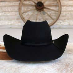 Introducing the Cody Johnson 9th Black Wool cowboy hat, meticulously crafted in the heart of Texas, USA, for true cowboy authenticity. Made from premium 3X wool, it features a commanding 4 5/8" bullrider crown and a versatile 4 1/4" brim, perfect for any adventure on or off the range. Complete with a stylish 2-ply hatband adorned with a hatpin, this hat is a symbol of rugged elegance for modern-day cowboys and cowgirls alike. 4 1/4" Brim 4 5/8" Bullrider Crown Color: Black 3X Wool Made in Texas, Cody Johnson, Girl Baseball Cap, Beaded Hat Bands, Leather Baseball Cap, Kids Belt, Beaded Hat, Feather Hat, Boy Hat, Leather Hats