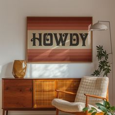 a chair sitting in front of a painting on the wall next to a wooden cabinet