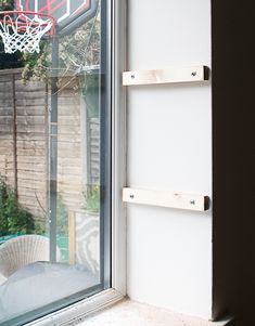 a basketball hoop hanging from the side of a window