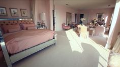 a bedroom with pink walls and white carpeted flooring is pictured in this image