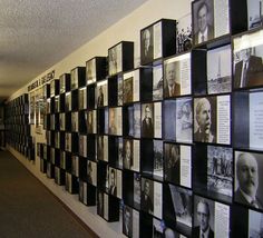 a long hallway with many framed pictures on the wall