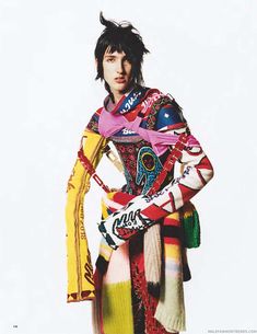 a man with black hair wearing colorful clothing