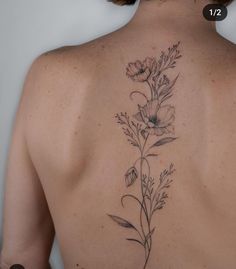 the back of a woman's neck with flowers on it