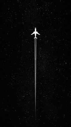 an airplane is flying high in the night sky with stars on it's side